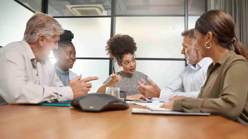 group of people at work in a meeting room having a challenging discussion